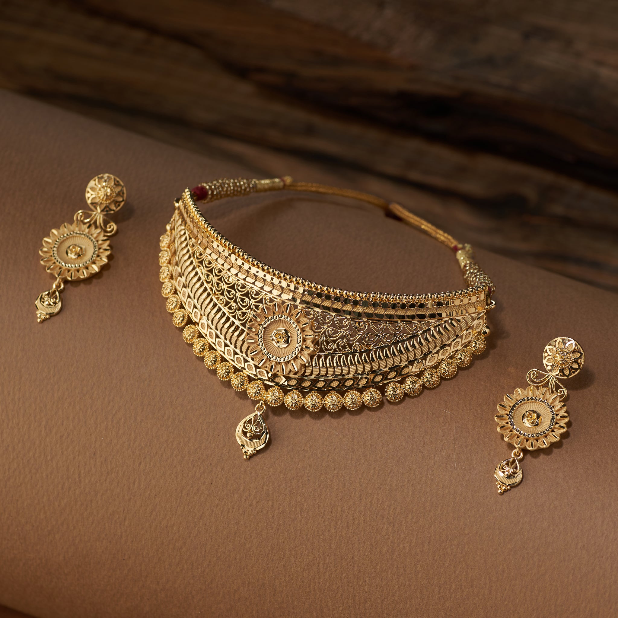 High gold lightweight bridal choker set with intricate filigree work and earrings