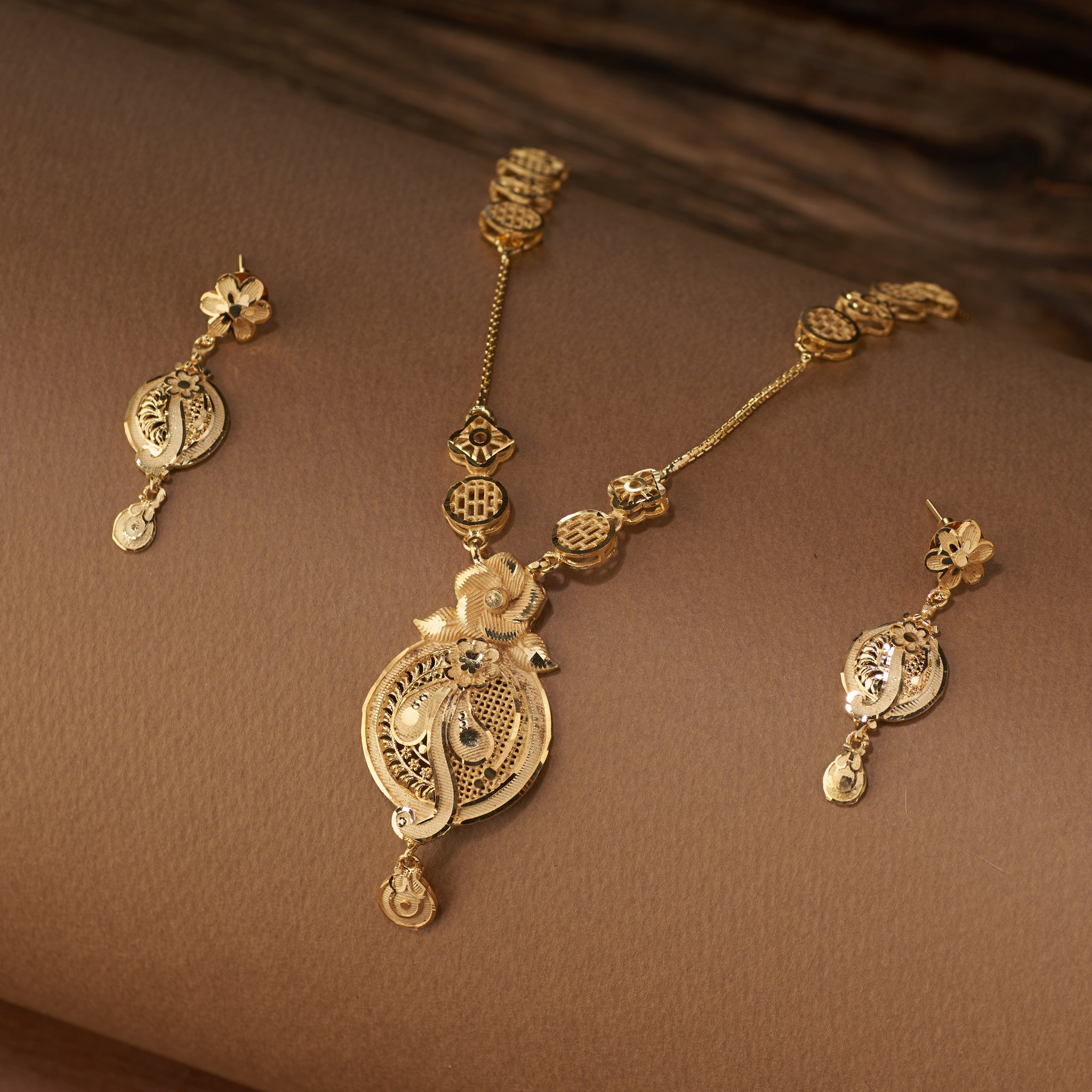 High gold long necklace set with intricate filigree pendant and matching drop earrings