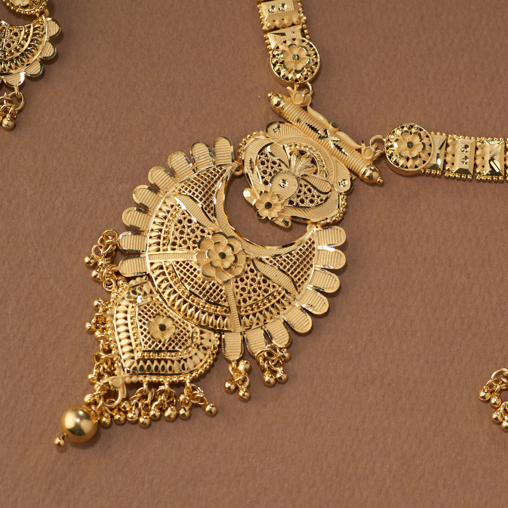 Gold necklace with intricate designs. Gold necklace with matching earrings. Gold Replica Rani Har Necklace Set | Rumika by Tilloma.