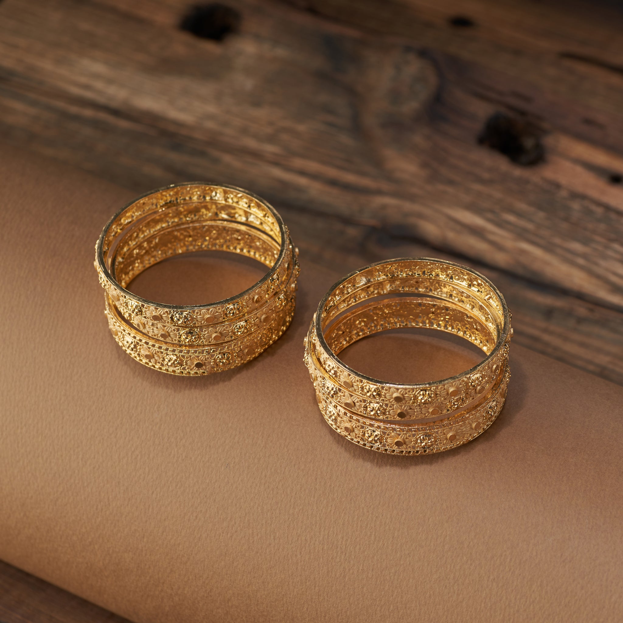 Complete your festive and bridal look with this stunning set of gold forming replica bangles. Designed with embossed floral motifs and intricate detailing, these bangles are the perfect accessory for weddings, cultural celebrations, and special occasions.