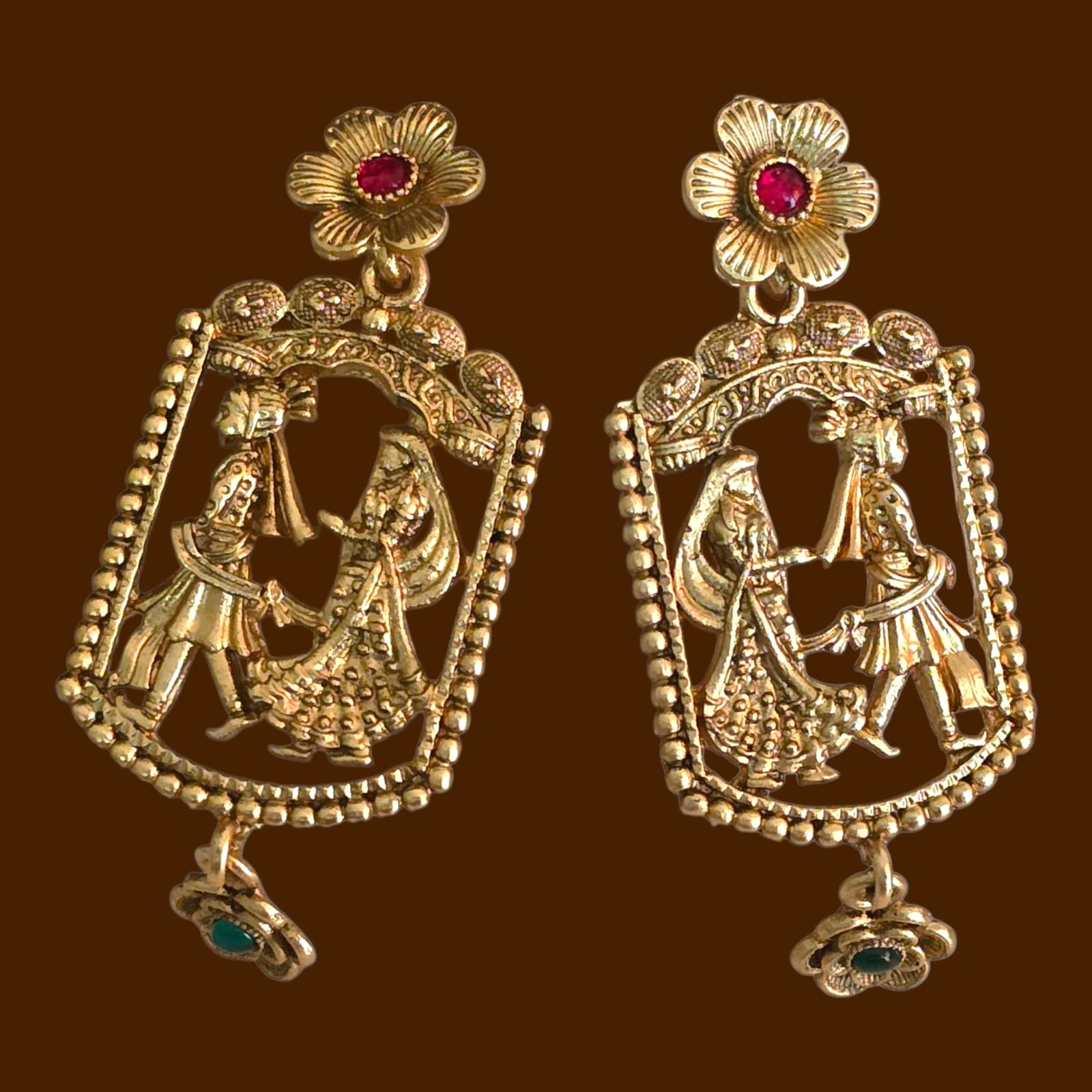 Gold replica temple earrings with intricate wedding ritual design, featuring bride and groom motif, antique finish, floral gemstone tops, and dangling charm – Special Occasion Collection bridal jewellery