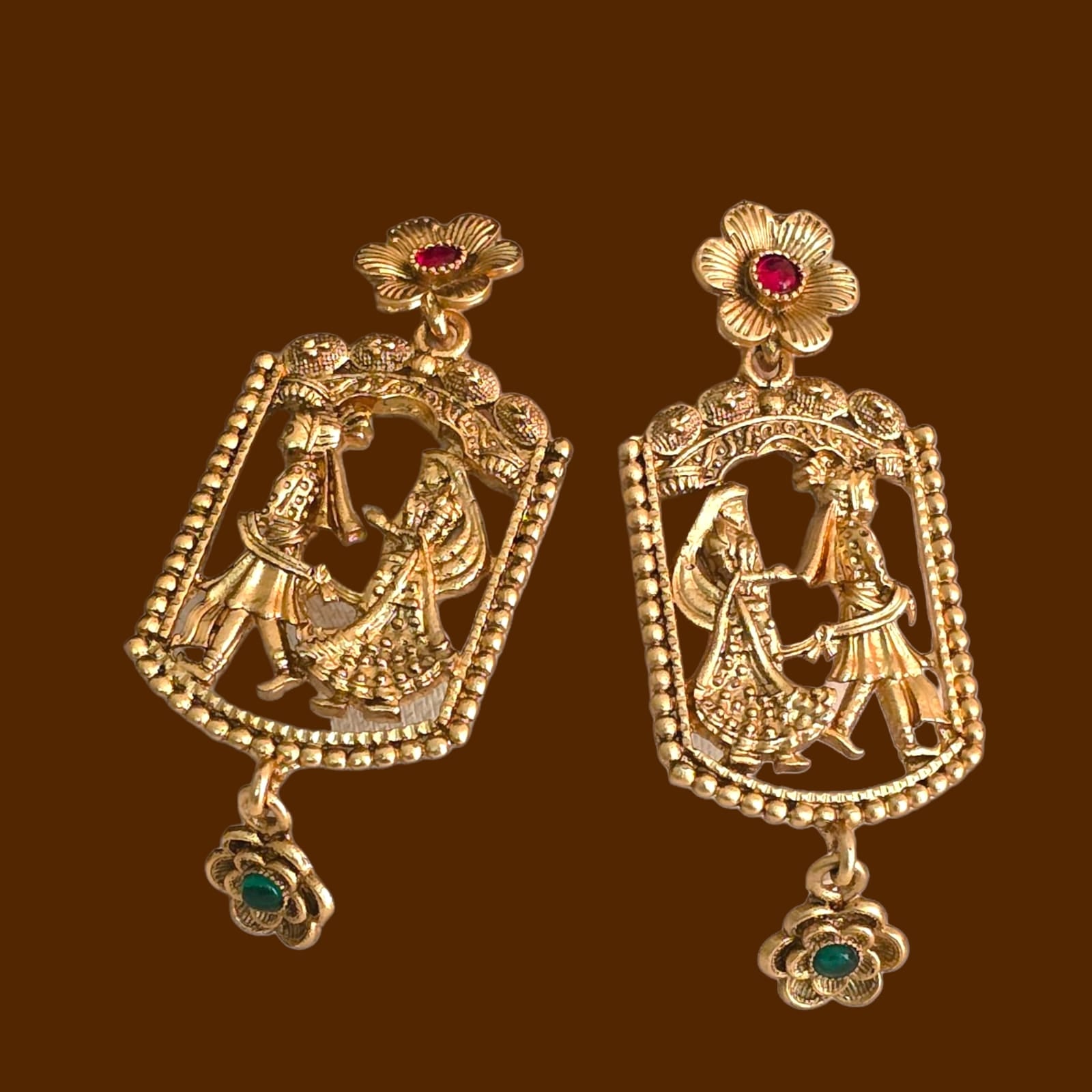 Gold replica temple earrings with intricate wedding ritual design, featuring bride and groom motif, antique finish, floral gemstone tops, and dangling charm – Special Occasion Collection bridal jewellery