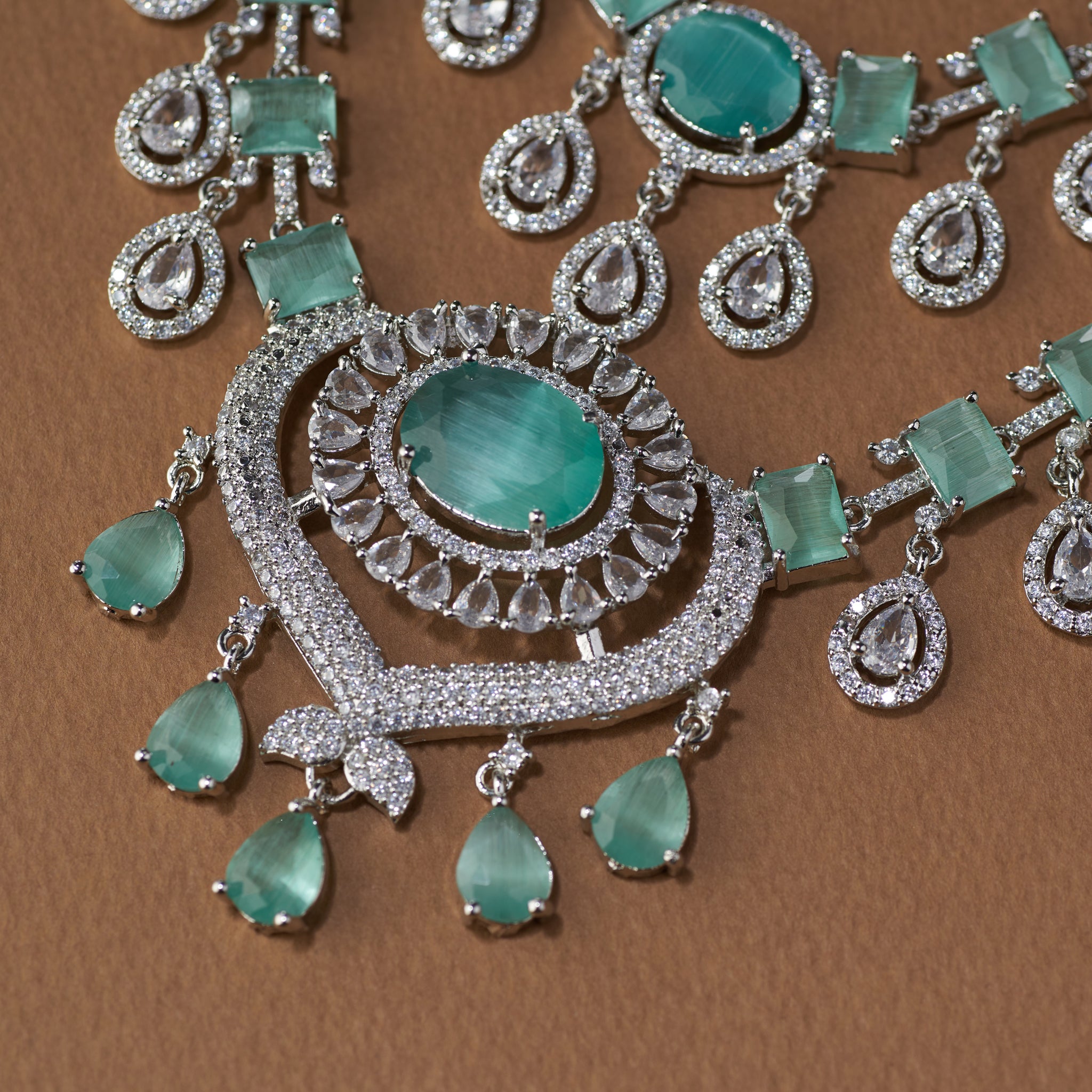 Ornate necklace with emerald green stones and silver accents