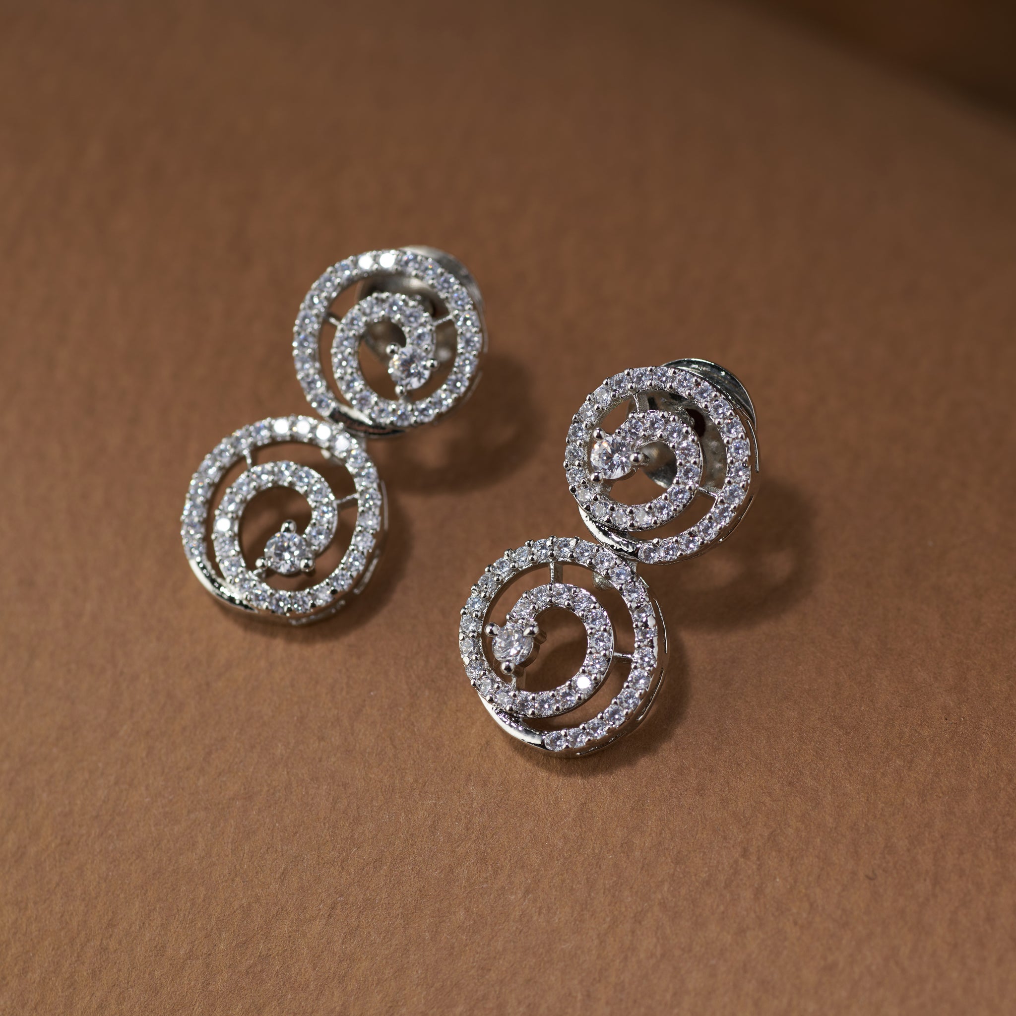 Silver spiral earrings. Silver plated zircon necklace and earrings. American diamond  radiant swirl by Tilloma.