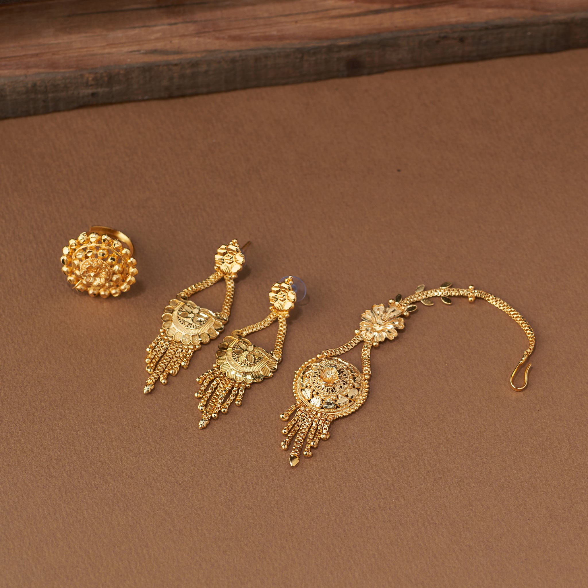 Traditional gold forming bridal jewellery set with short necklace, choker, long haaram, earrings, maang tikka and ring – perfect Indian bridal wedding jewellery with intricate temple-inspired design.