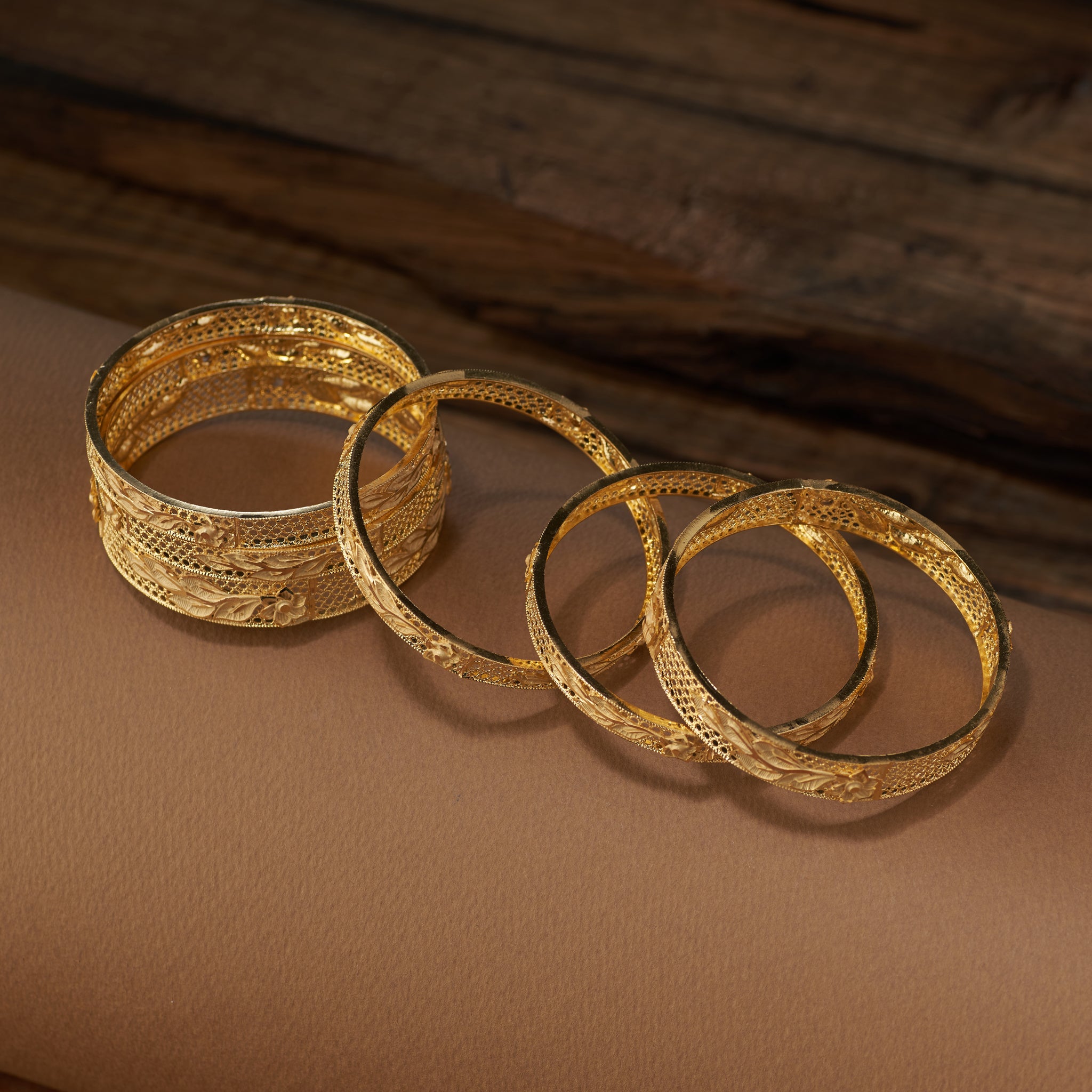 Discover the beauty of handcrafted gold forming replica bangles with detailed floral and leaf cutwork design. This versatile jewellery set is ideal for weddings, bridal looks, festive celebrations, and special occasions – bringing a touch of tradition and elegance to every outfit.