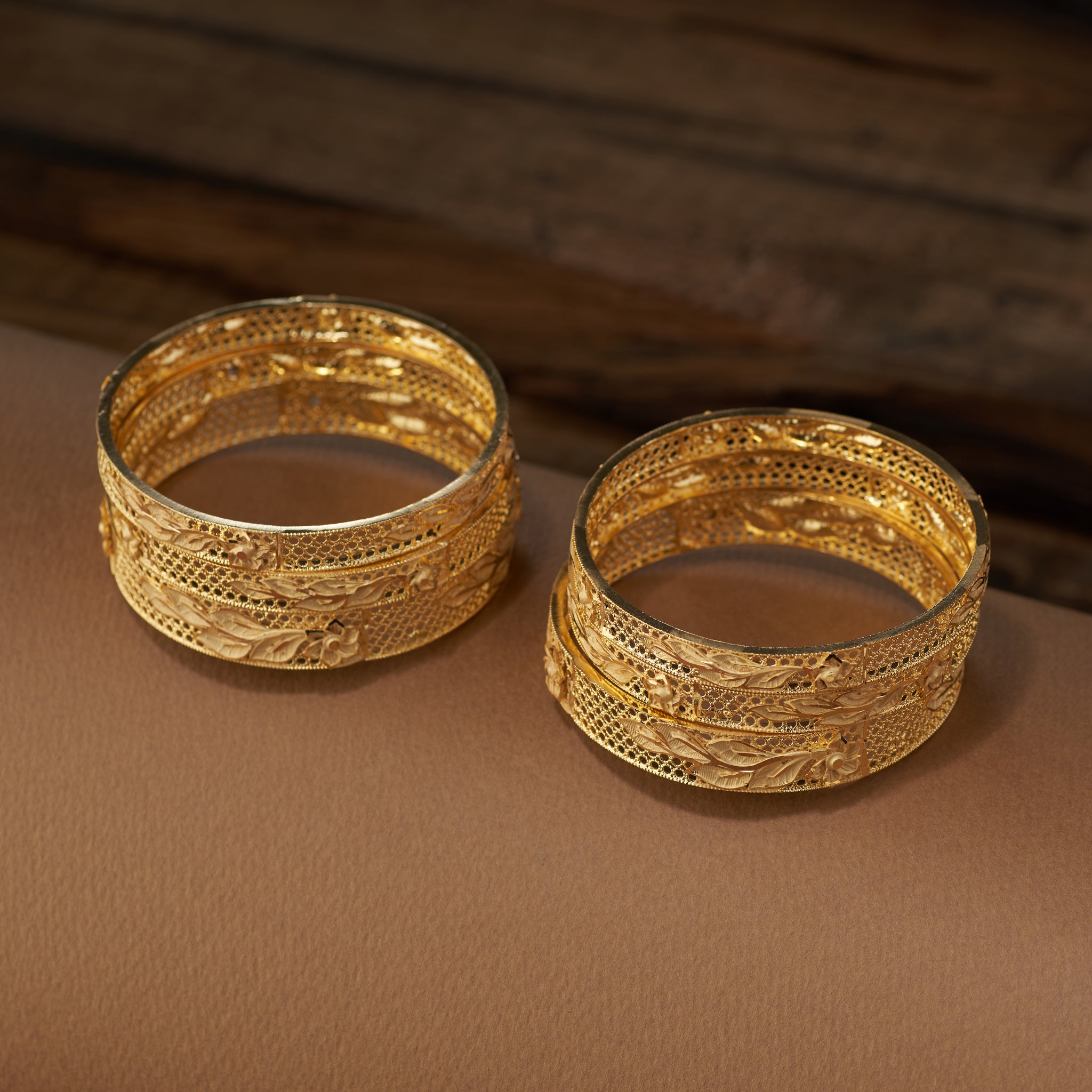 Discover the beauty of handcrafted gold forming replica bangles with detailed floral and leaf cutwork design. This versatile jewellery set is ideal for weddings, bridal looks, festive celebrations, and special occasions – bringing a touch of tradition and elegance to every outfit.