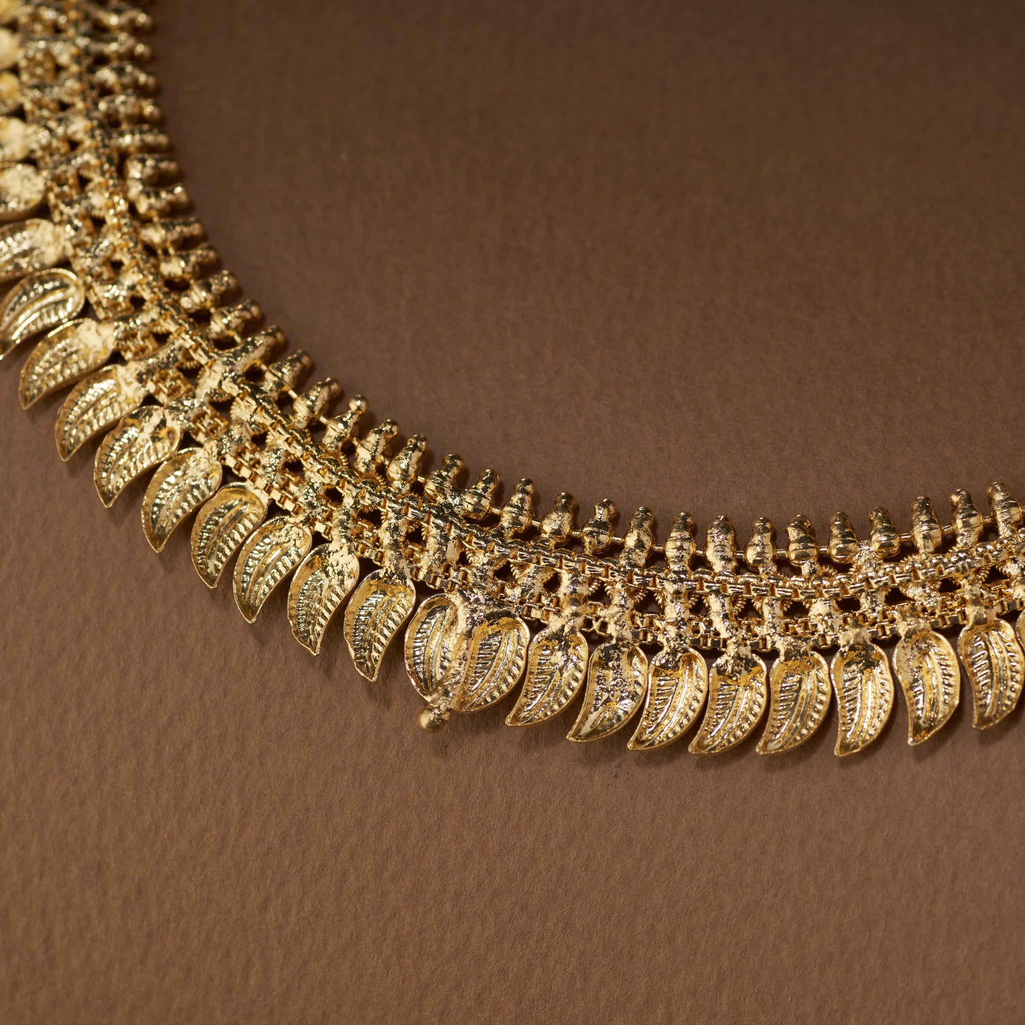 Gold necklace with intricate design  mango leaf pattern. Gold necklace with matching earrings. Gold Forming Necklace Set | Kumarika by Tilloma.