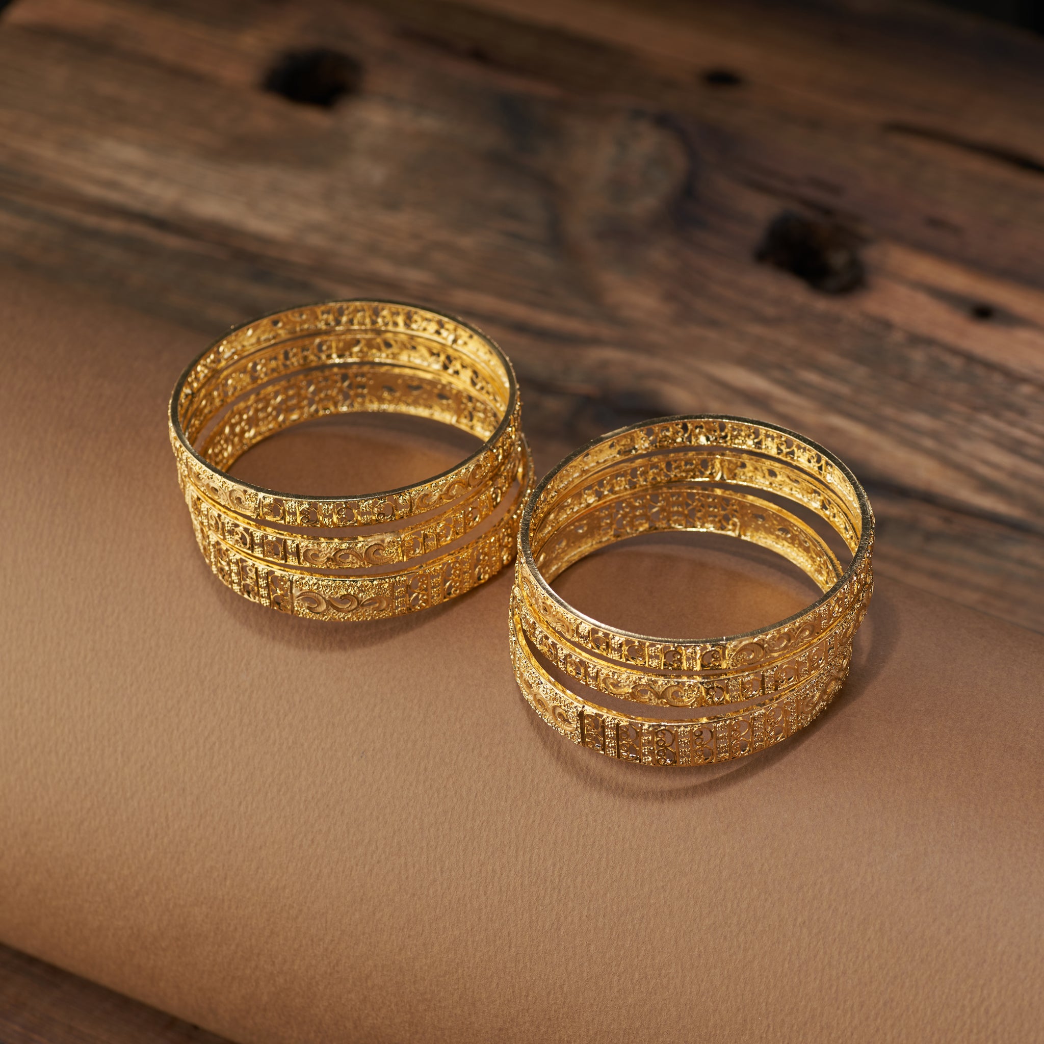 Add timeless elegance to your jewellery collection with this gold forming replica bangles set. Featuring detailed filigree and floral craftsmanship, these bangles are ideal for weddings, festive celebrations, and special occasions – the perfect blend of tradition and style.