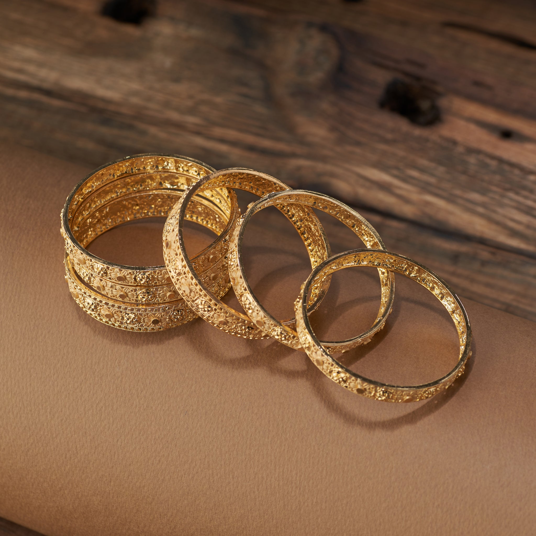 Complete your festive and bridal look with this stunning set of gold forming replica bangles. Designed with embossed floral motifs and intricate detailing, these bangles are the perfect accessory for weddings, cultural celebrations, and special occasions.