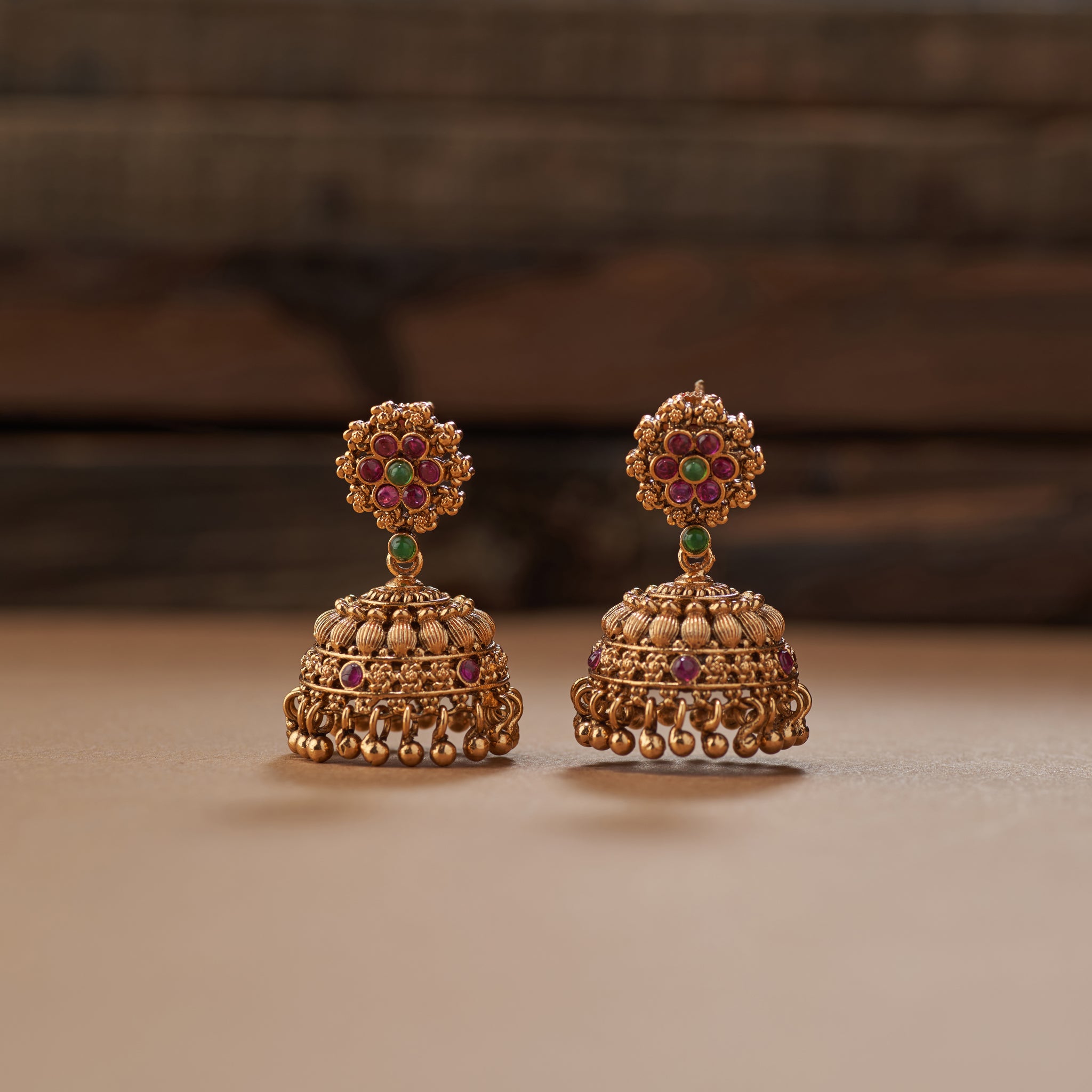 "Intricate heritage temple jewellery choker in antique gold with colourful stone detailing and matching earrings close up